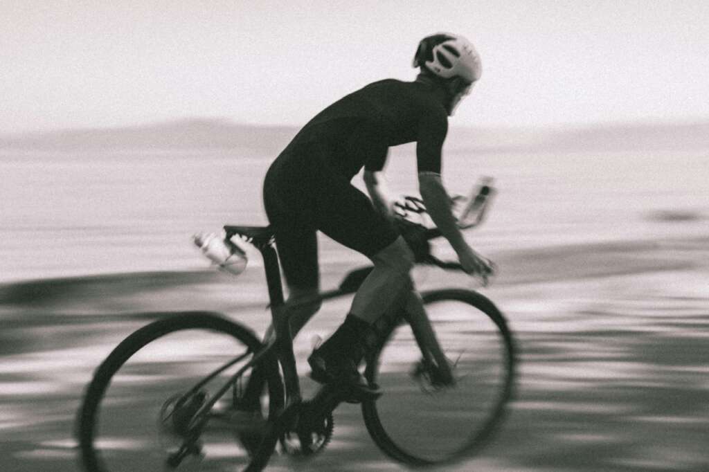 What Is the Best Sports Equipment For Triathlons? What Is the Best Sports Equipment For Triathlons 2 Cyclist riding near water, blurred motion doing the best sports for cardio fintess