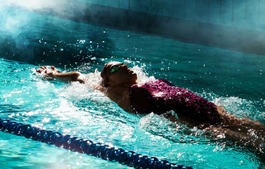 Person swimming in a pool doing the best sports for cardio fitness