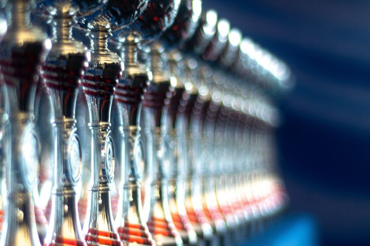 A row of sports awards cups